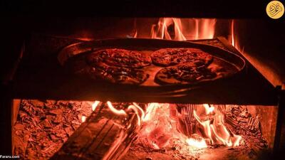 (تصاویر) پخت پیتزا روی آتش هیزم در غزه